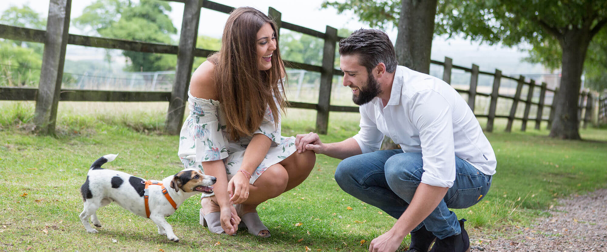 Happy couple with dog on engagement shoot