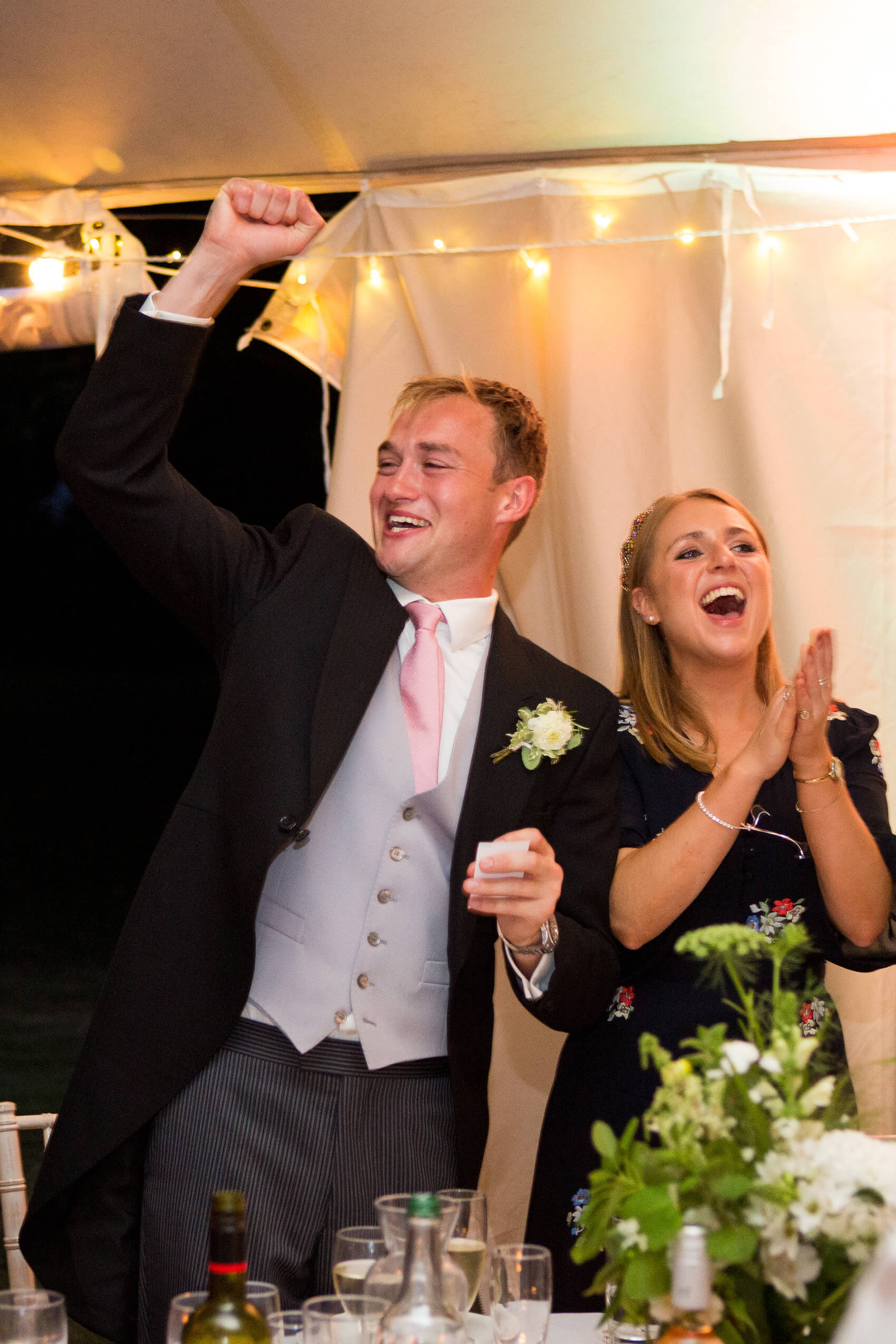 Man and woman dancing and laughing at a wedding