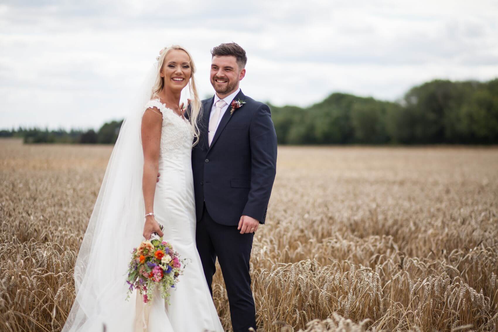 Bride and groom in the cornfields at Bassmead Mannor