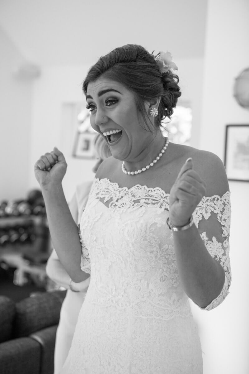 Black and white image of an excited bride 