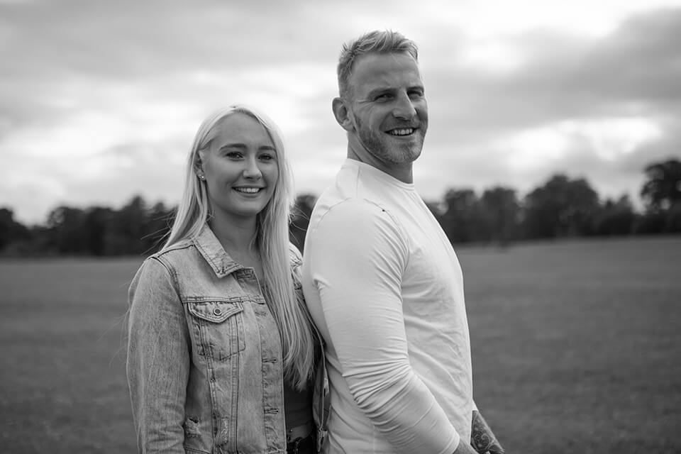 black and white photo of an engaged couple looking happy