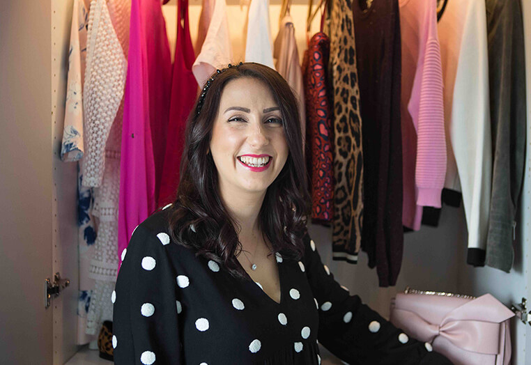 Woman showing of a range of different clothing and accessories