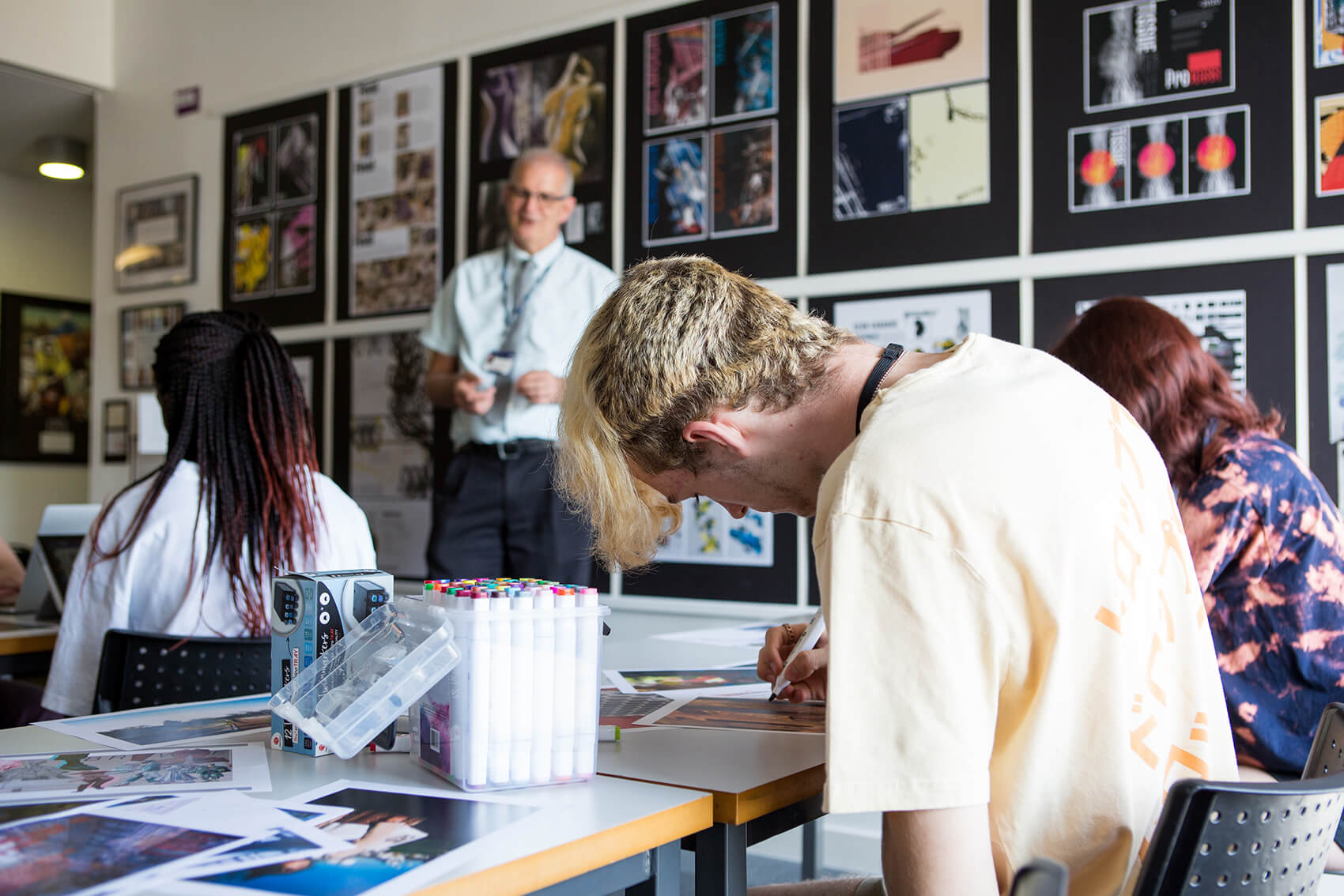 Students at tables while drawing