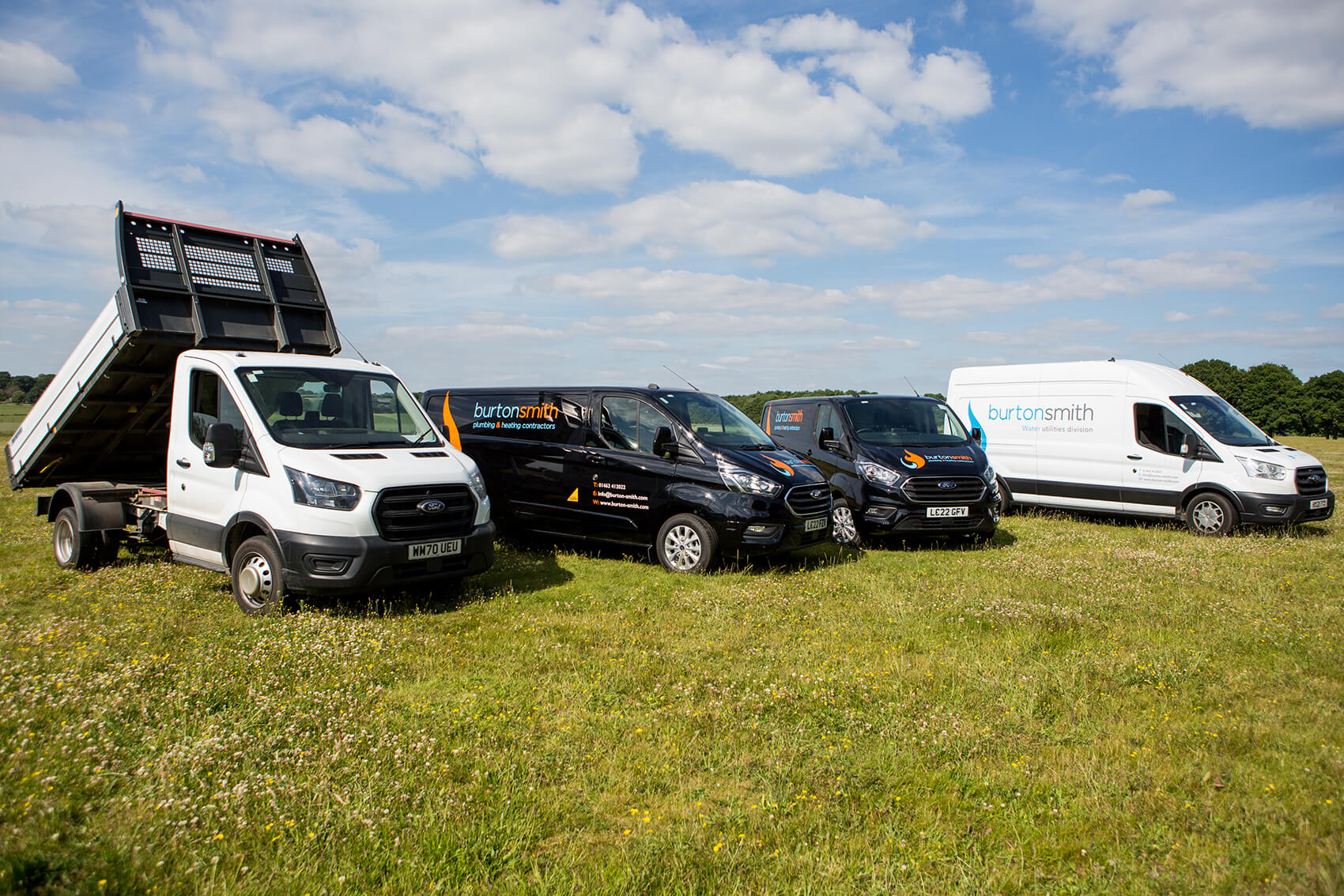 Work vans in a row on grass