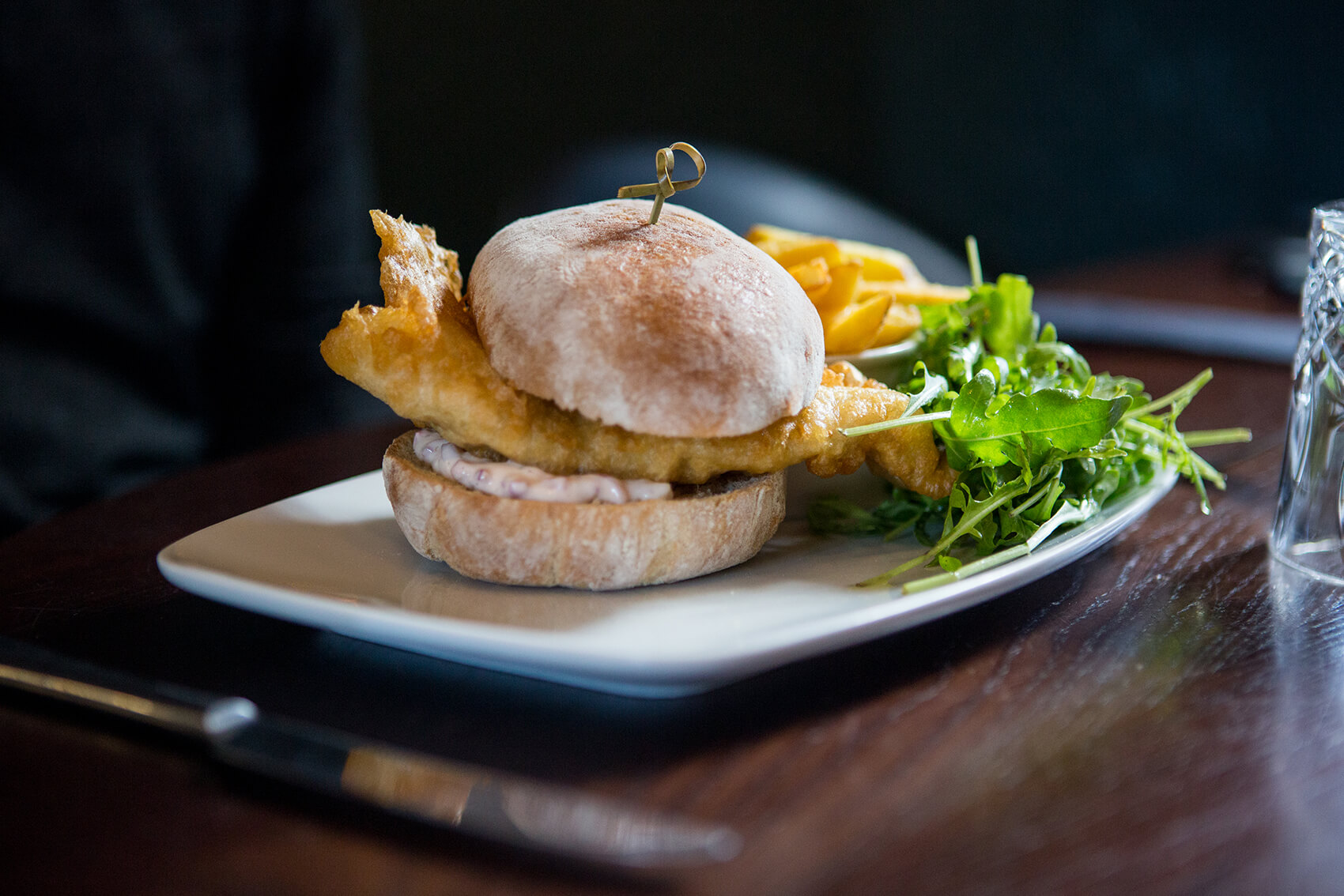 A fish burger on a table