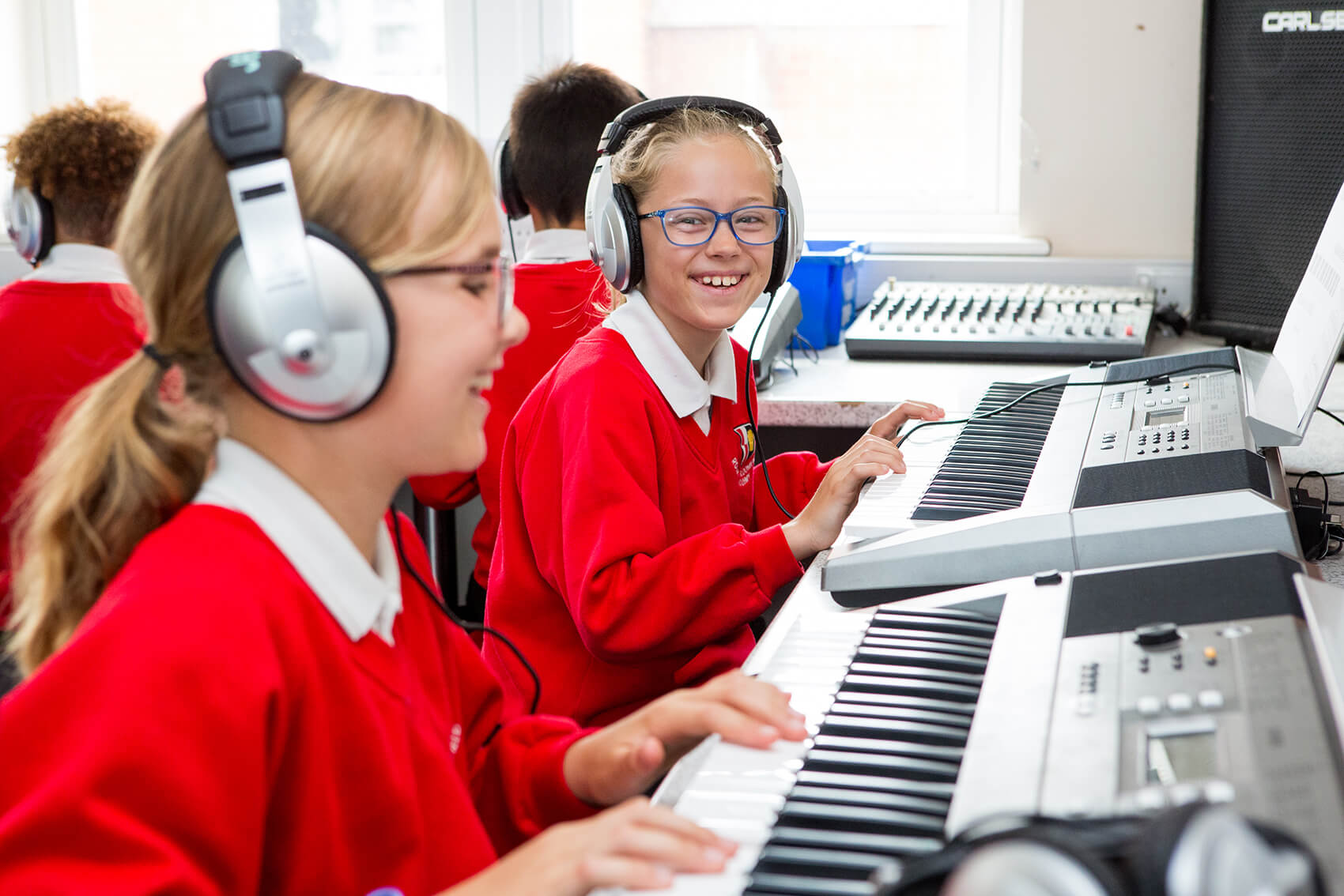 Children at school playing the piano