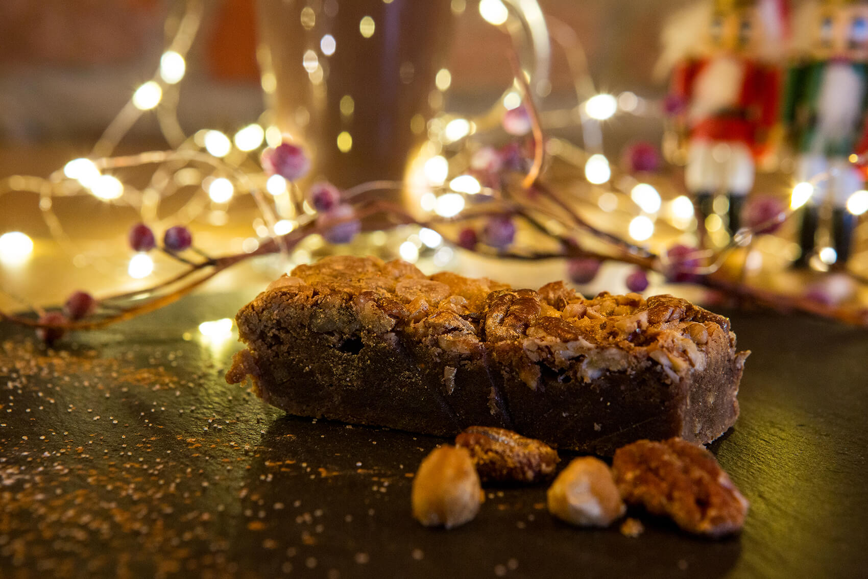 Cake on a table with fairy lights in the background