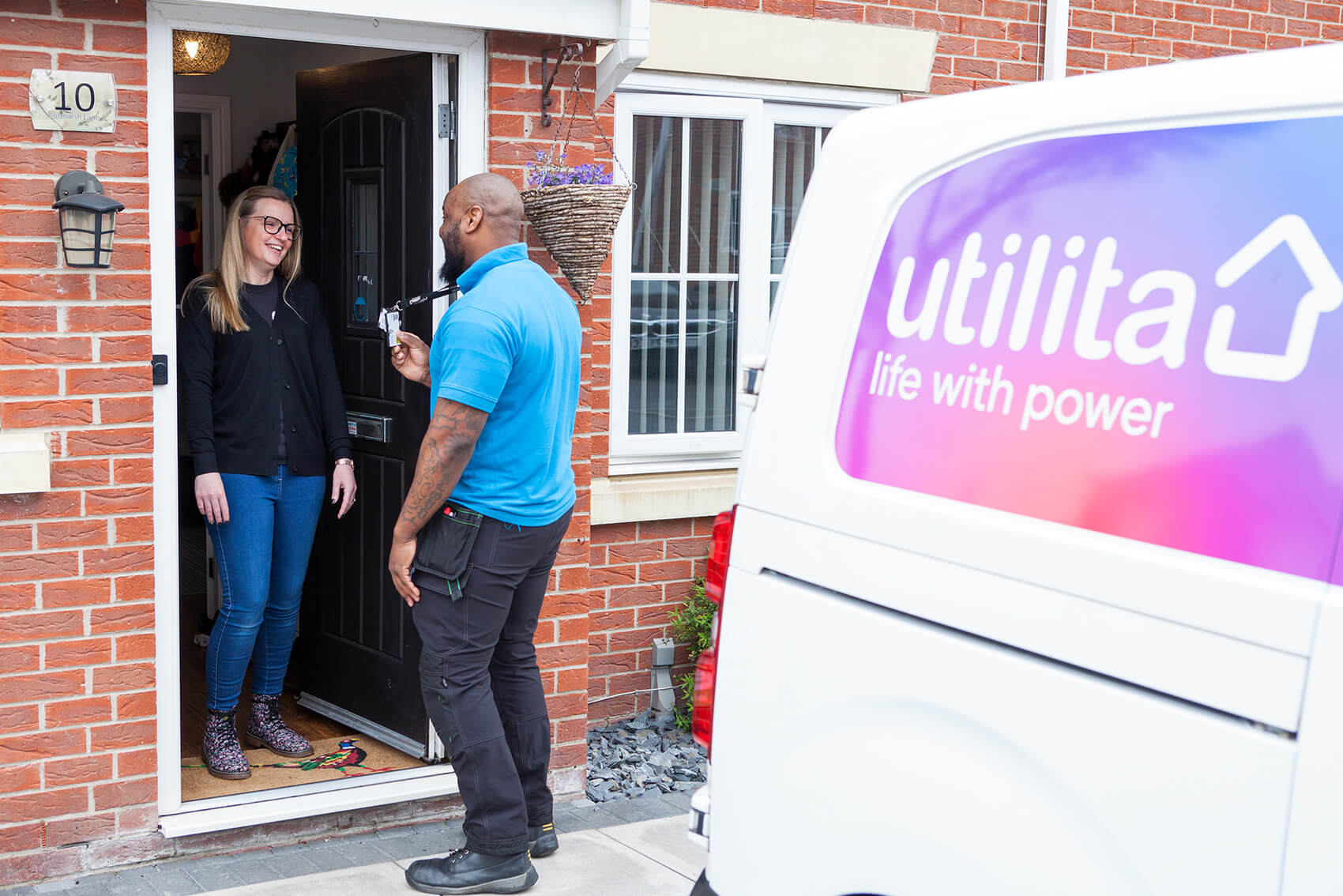 Man in front of a house talking to a woman