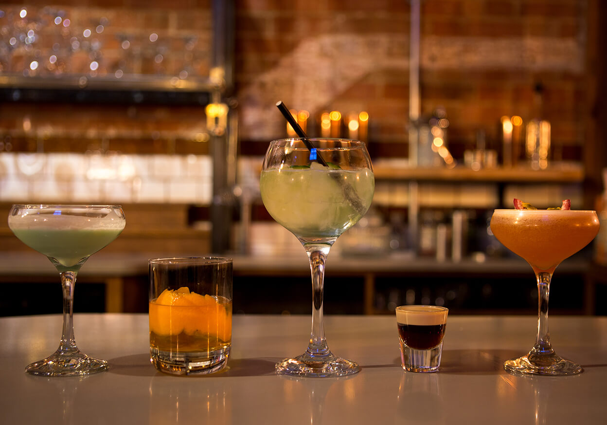 A variety of different drinks in different shaped glasses