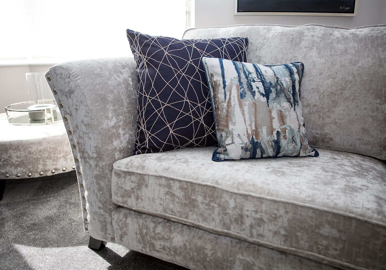 Assortment of pillows on a grey sofa