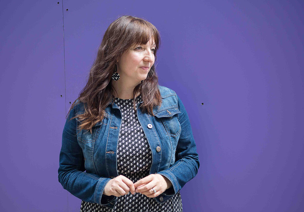 Woman looking into the distance on a purple background