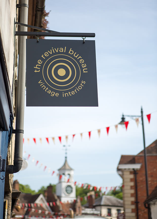 Store signage with the back drop of bunting and a clock tower