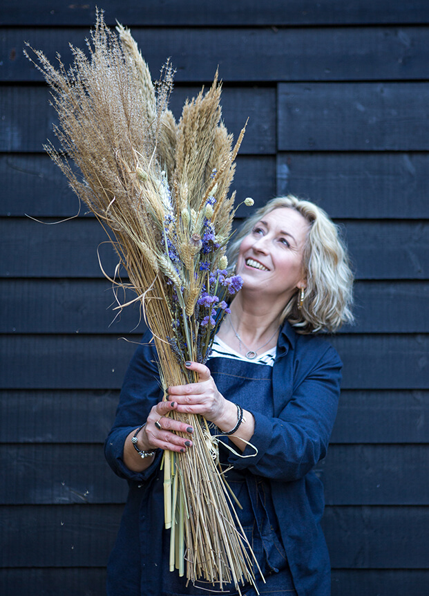 Woman holding a variety of different flowers