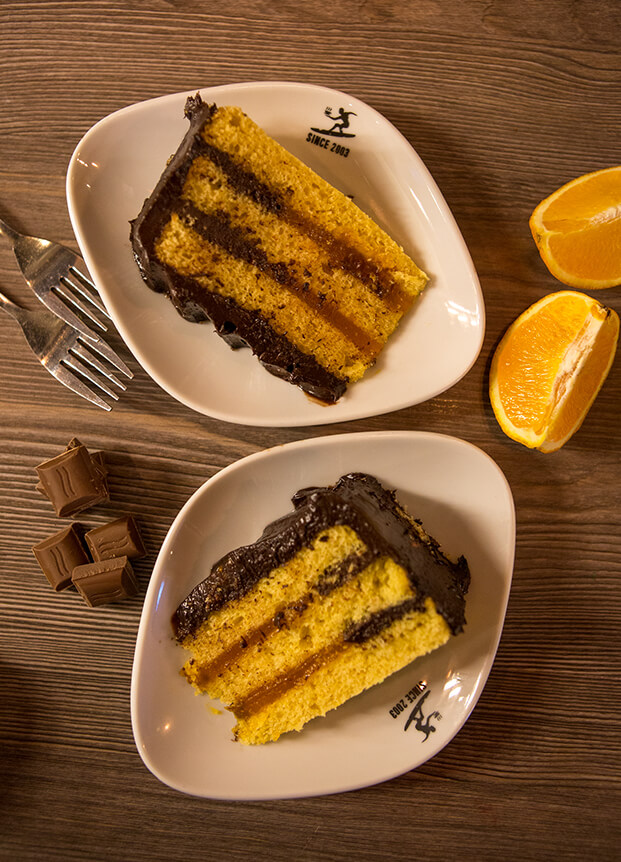 Two slices of cake on white plates