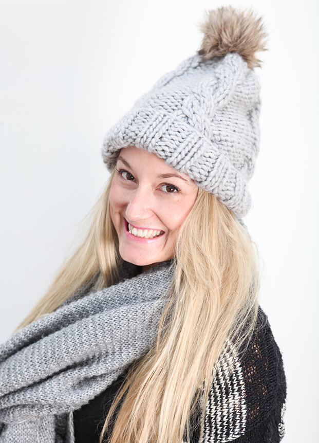 Woman in a grey woolly hat and scarf