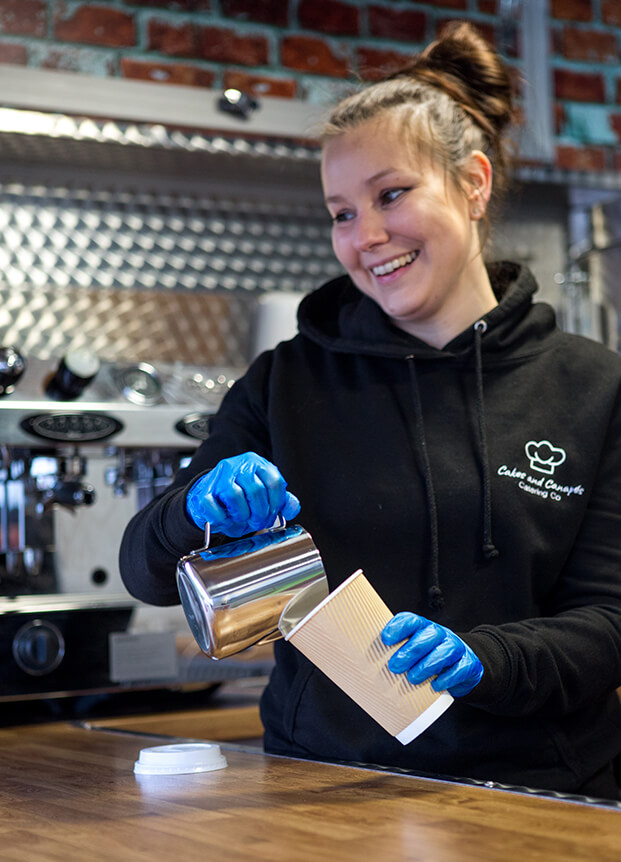 Woman pouring milk into a cardboard container