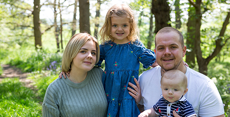 A family sitting together in the woods