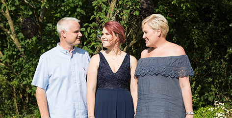 A mum and dad with daughter on her prom day