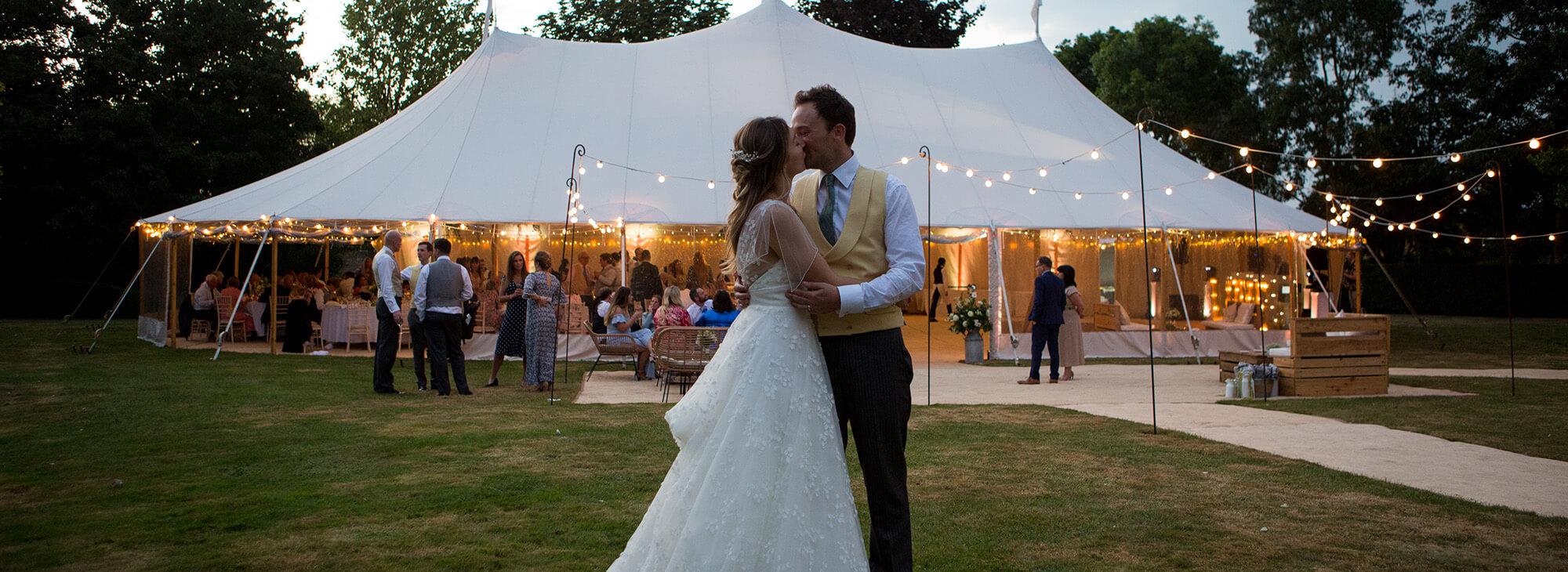 Happy newly married couple smiling after leaving wedding venue