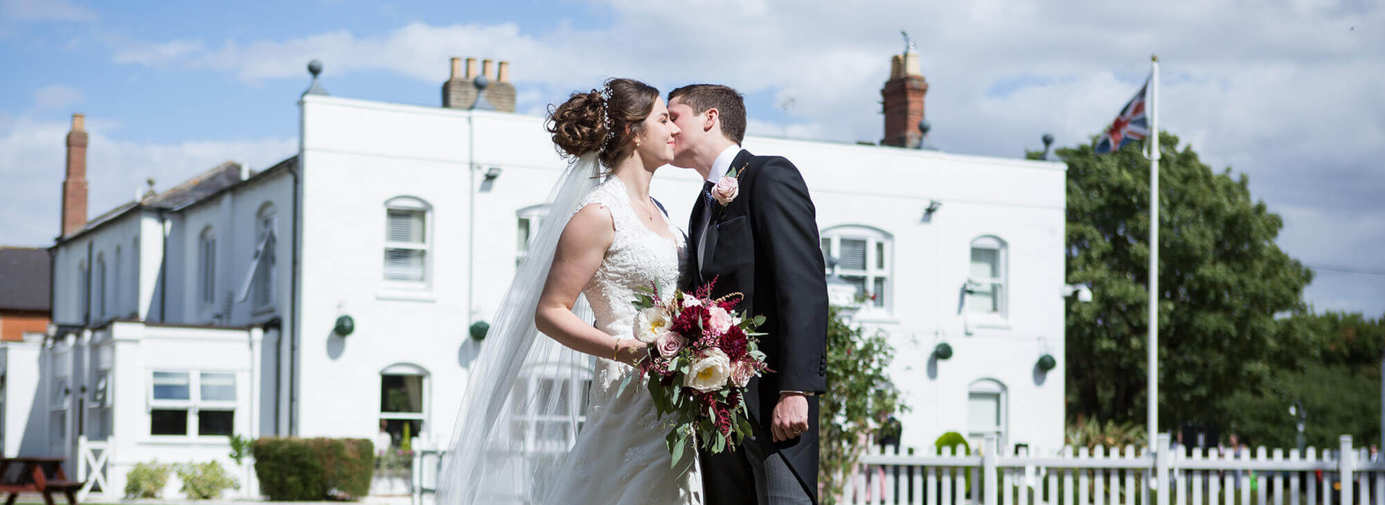 Happy couple smiling walking through garden