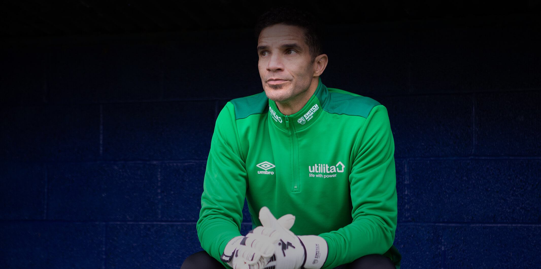 David James sitting on a dug out bench