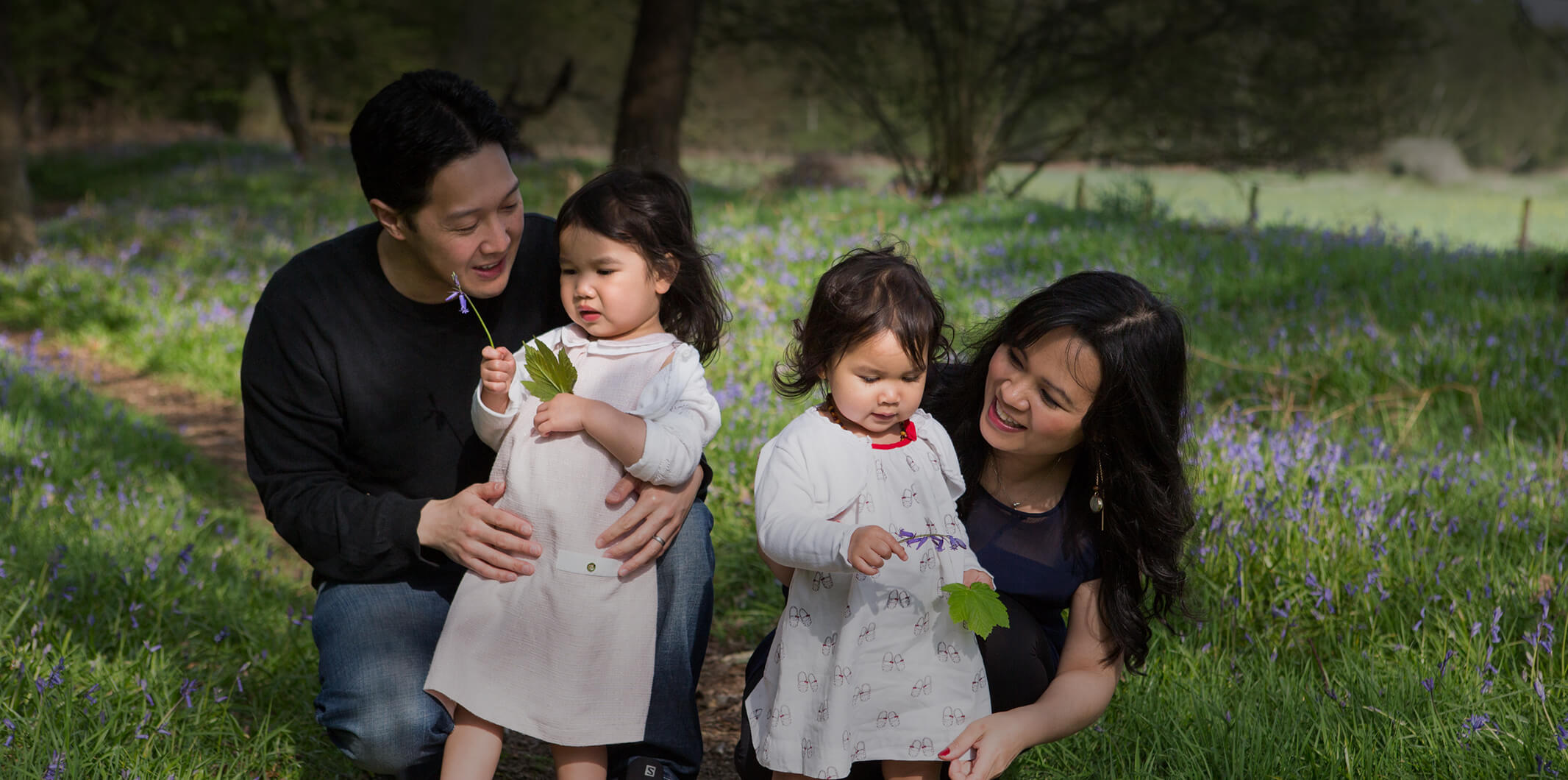 A happy family walking through a wood