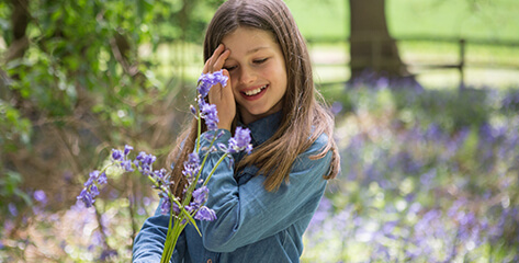 Young girl playing out in some flowers