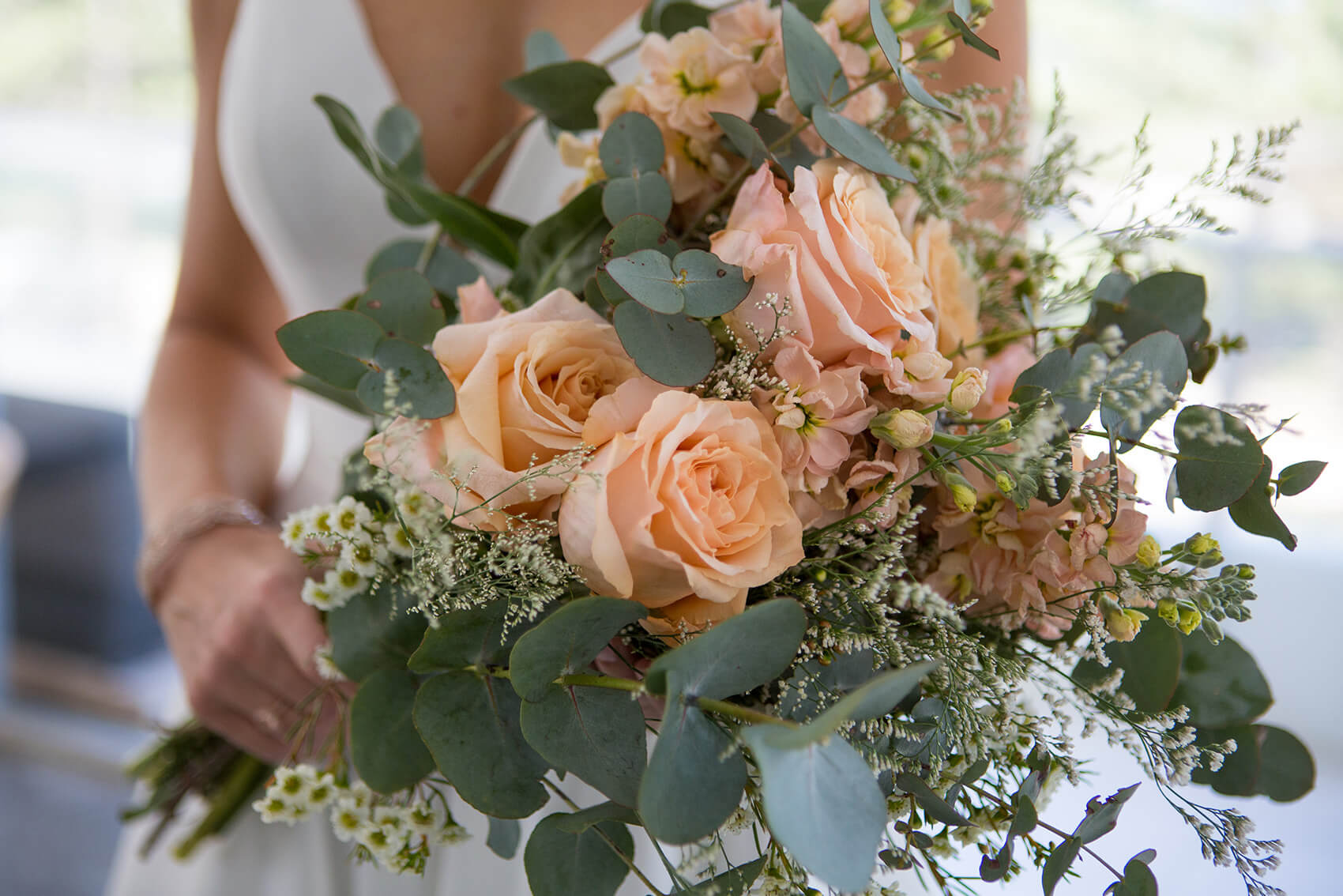 A bridesmaid holding flowers