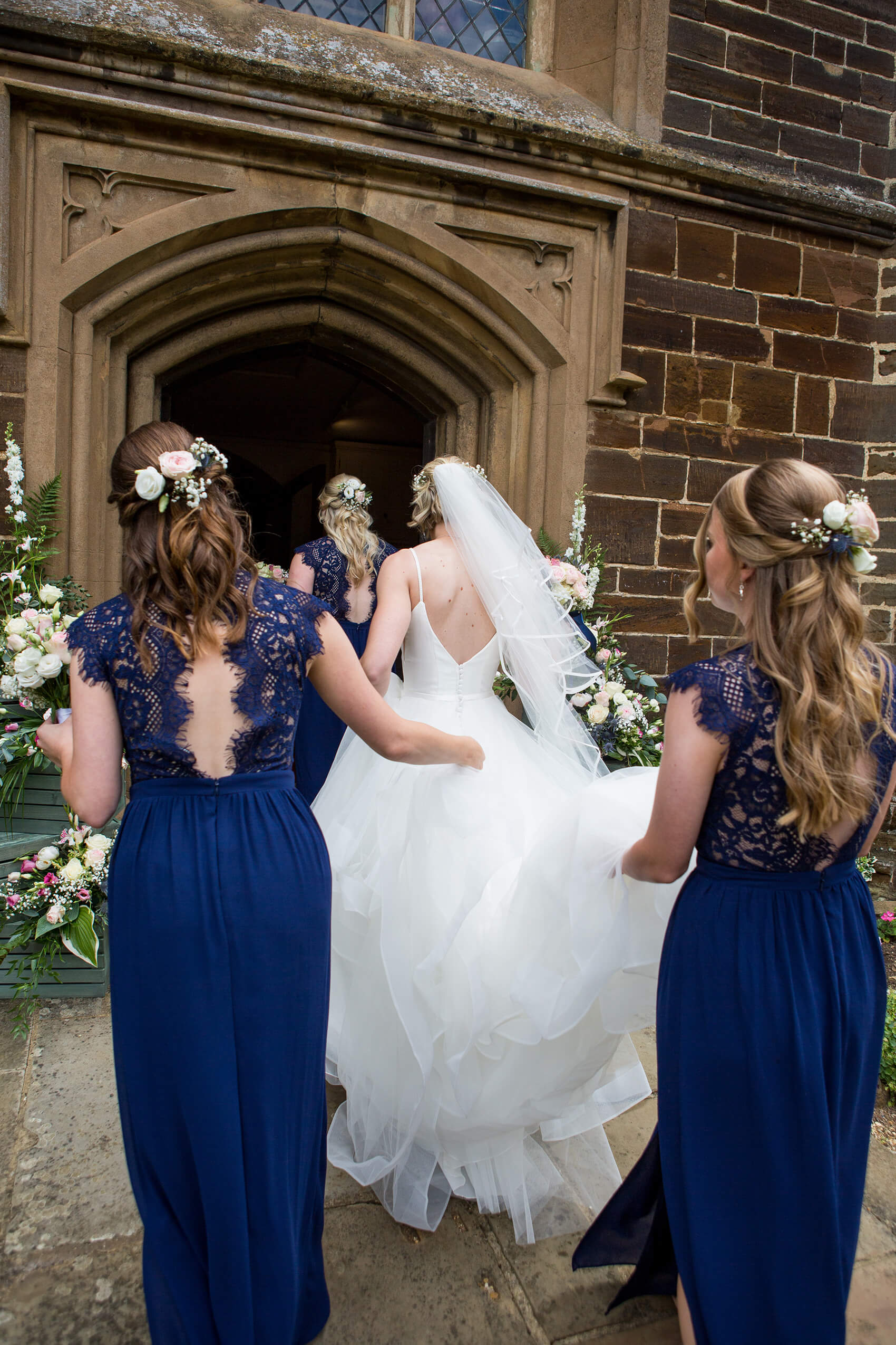 Bride and bridesmaids walking into a church