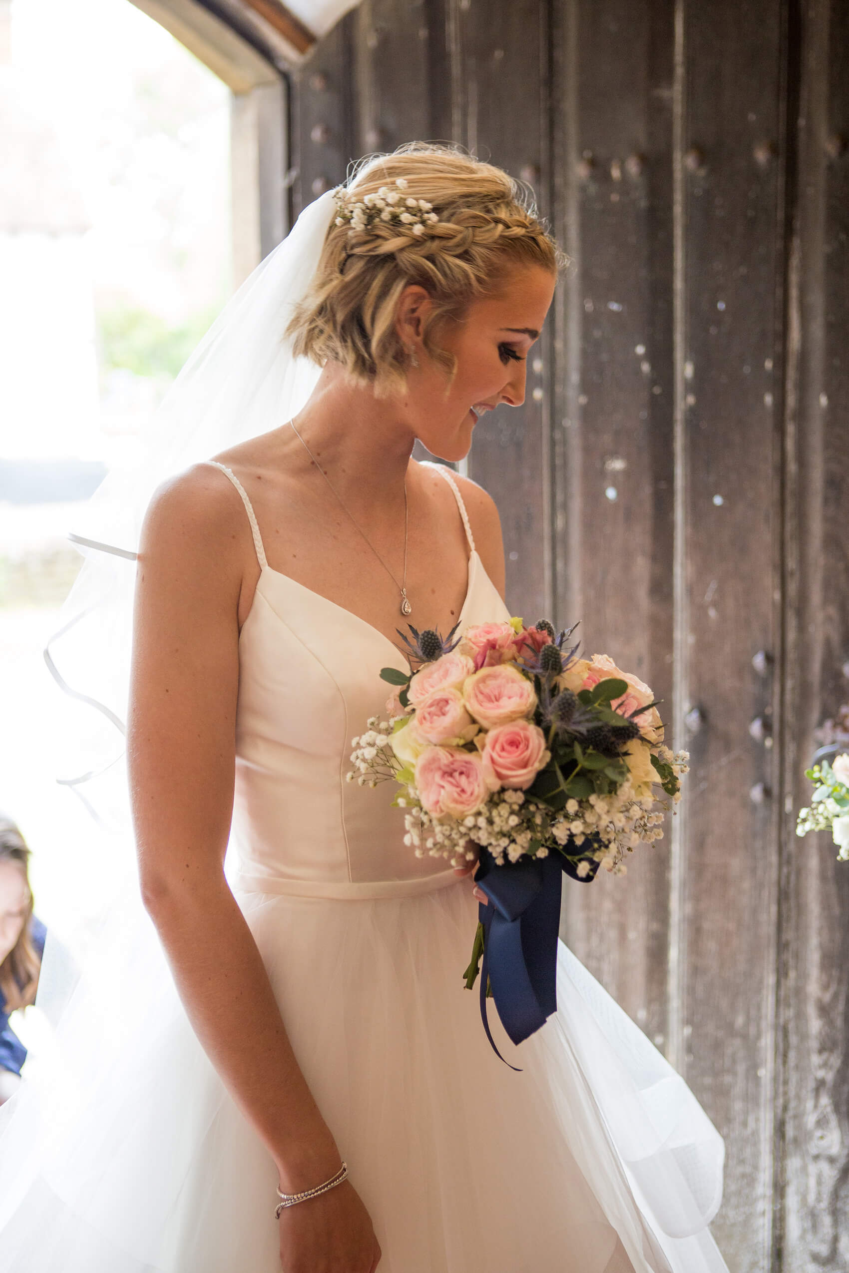 Bride holding flowers and smiling