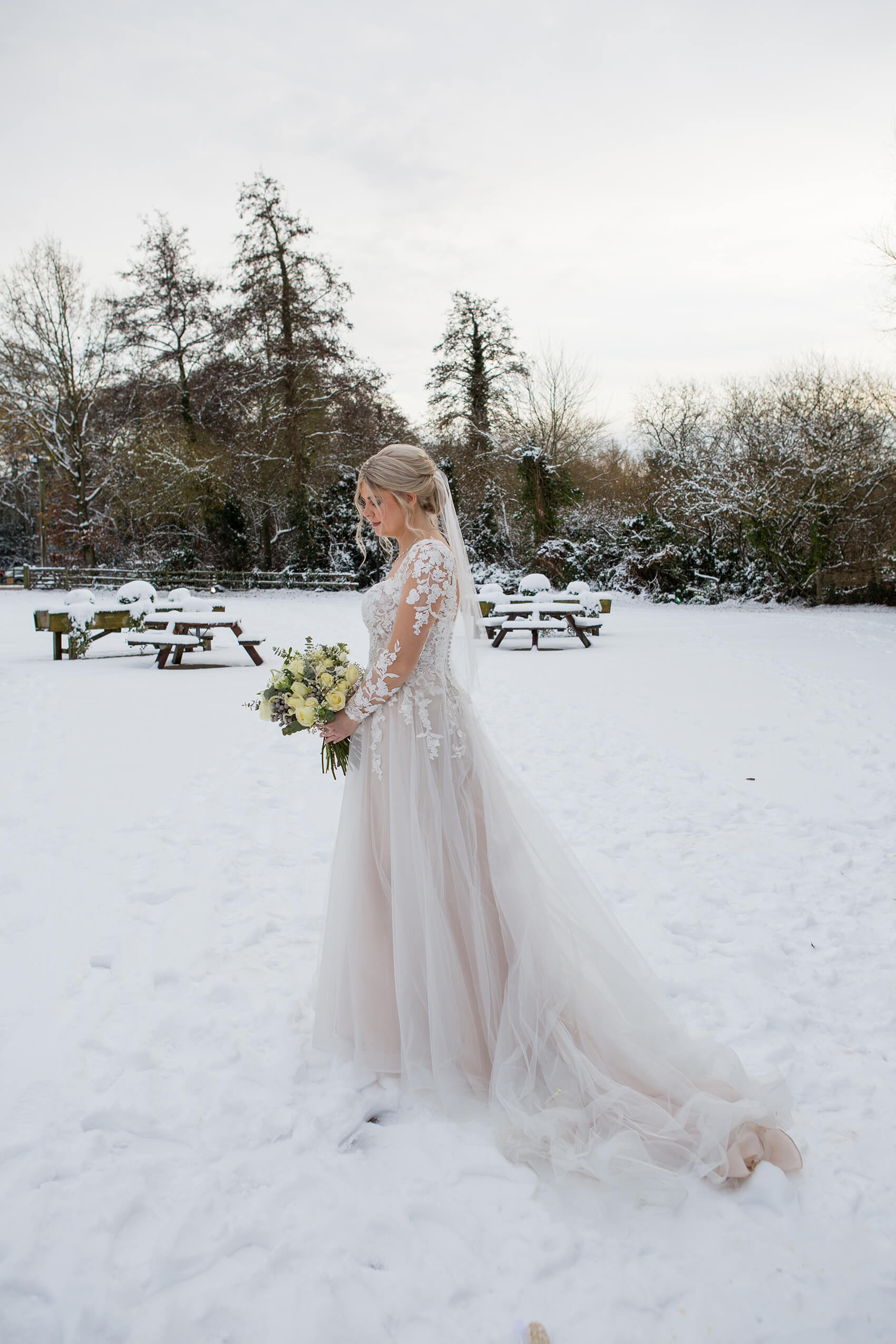 A bride standing in the snow