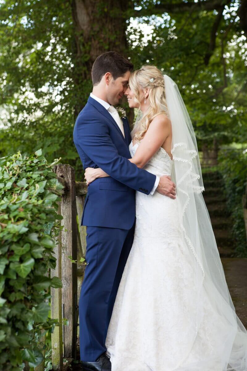 Bride and groom on a bridge at Hexton Mannor Hertfordshire 