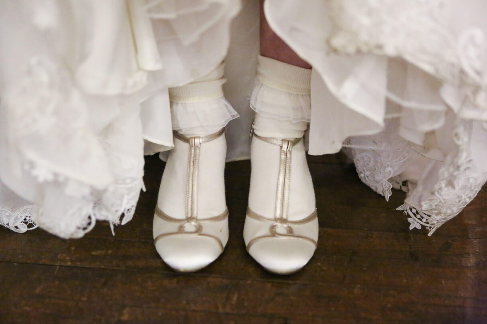 Bride's beautiful cream wedding shoes at Evershoult Hall 