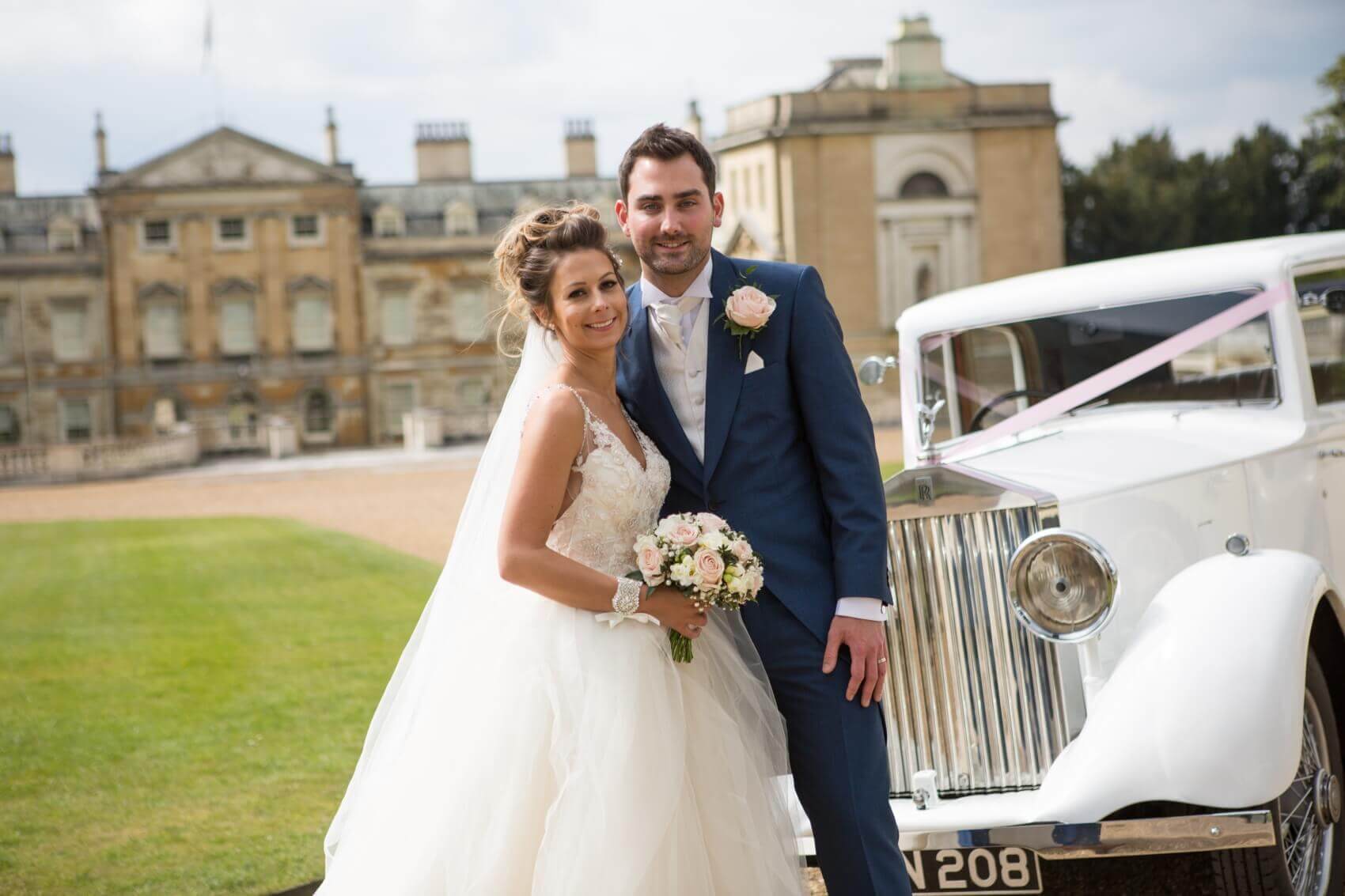 Bedfordshire wedding photographer at The sculpture Gallery in Woburn with the bride and groom and a white vintage wedding car