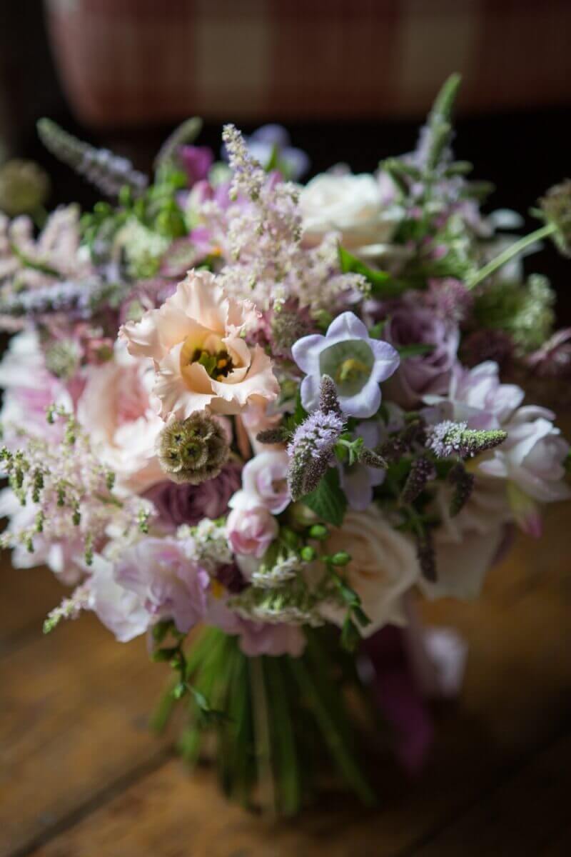 Flowers by Millie Richardson florist wedding bouquet of light colours on a wooden floor
