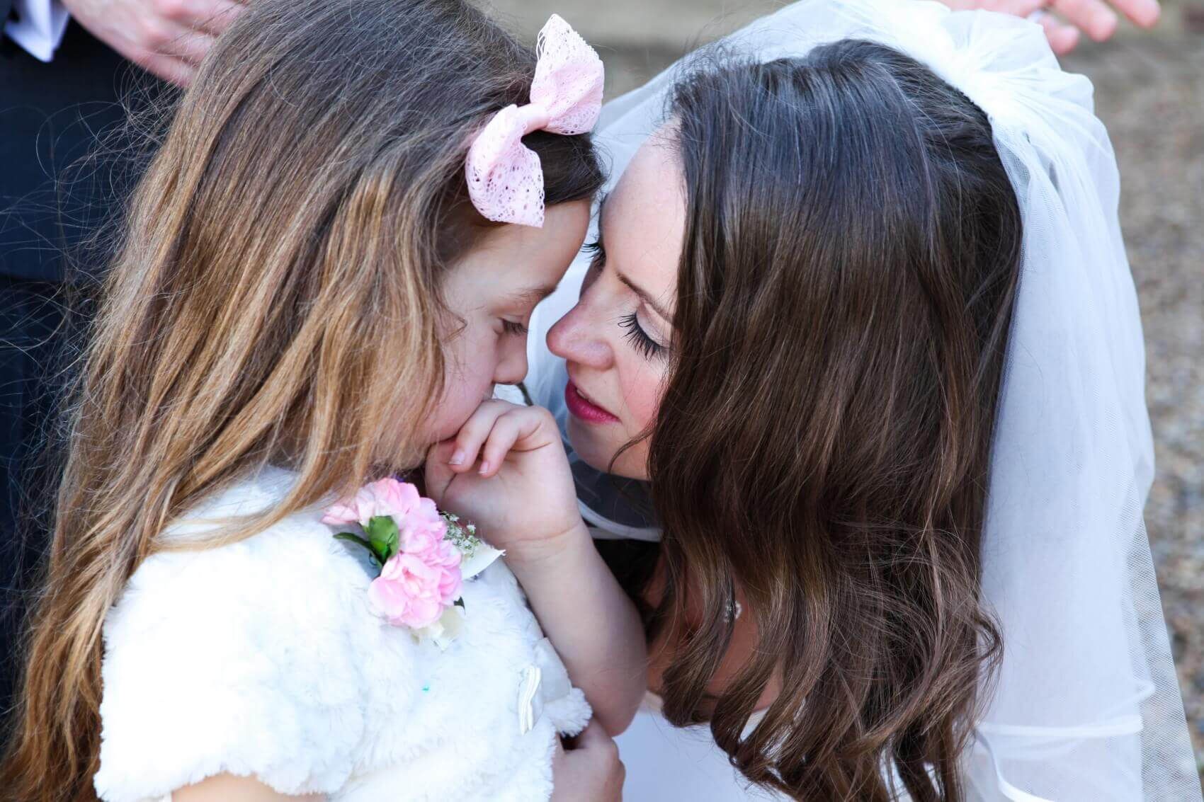 Kisses for the bridesmaid from the beautiful bride at Flitwick Manor  